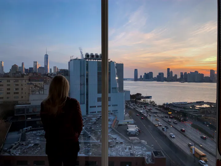Illustrative photo of a woman quietly looking out a window