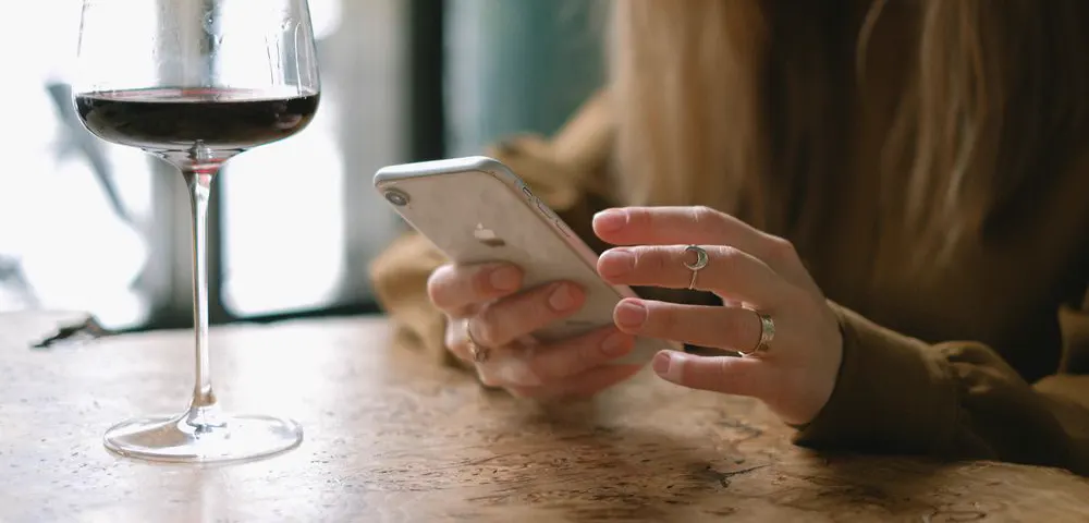 Illustrative scene: a phone held at a cafe table after a date