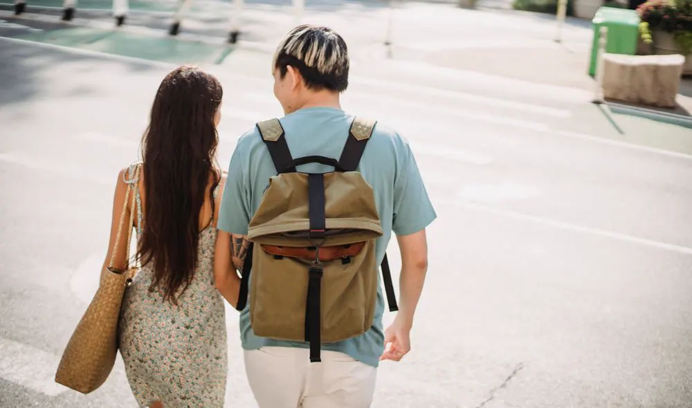 Illustrative scene: two people walking together on a city street, seen from behind